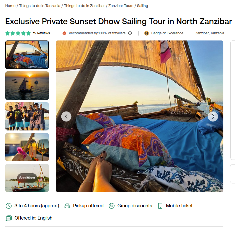 A relaxing view from a dhow at sunset in Zanzibar, featuring cozy cushions, a serene ocean, and a colorful sail.